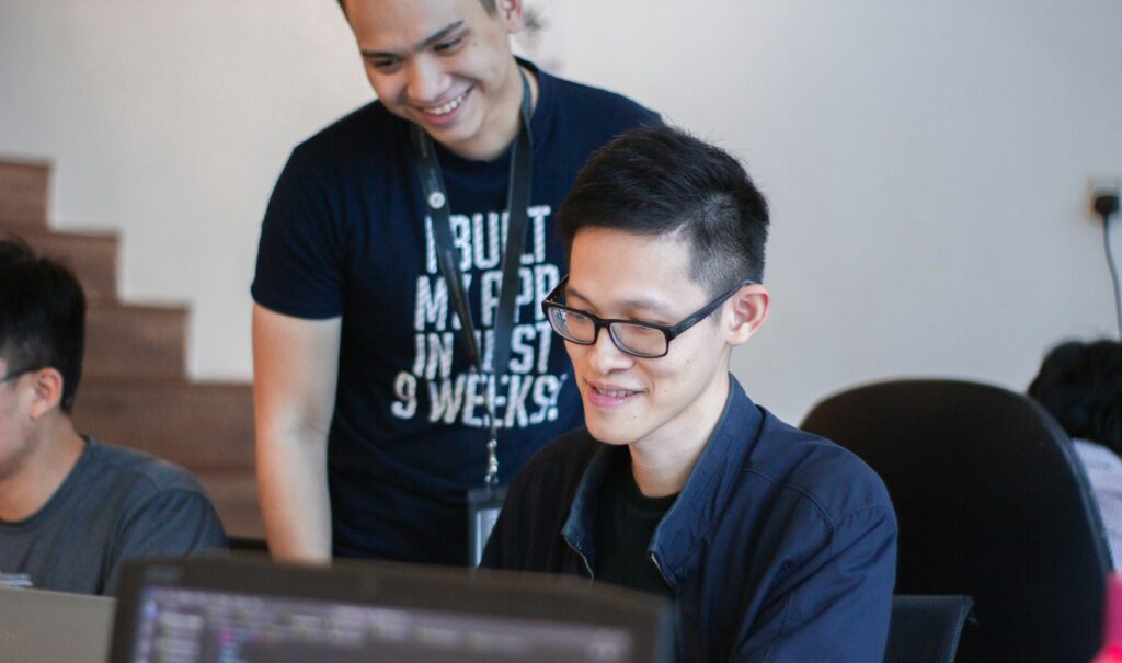 Smiling man learning on a laptop